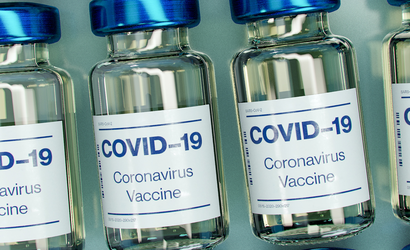 Close-up of Covid-19 vaccine vials laid out in rows.